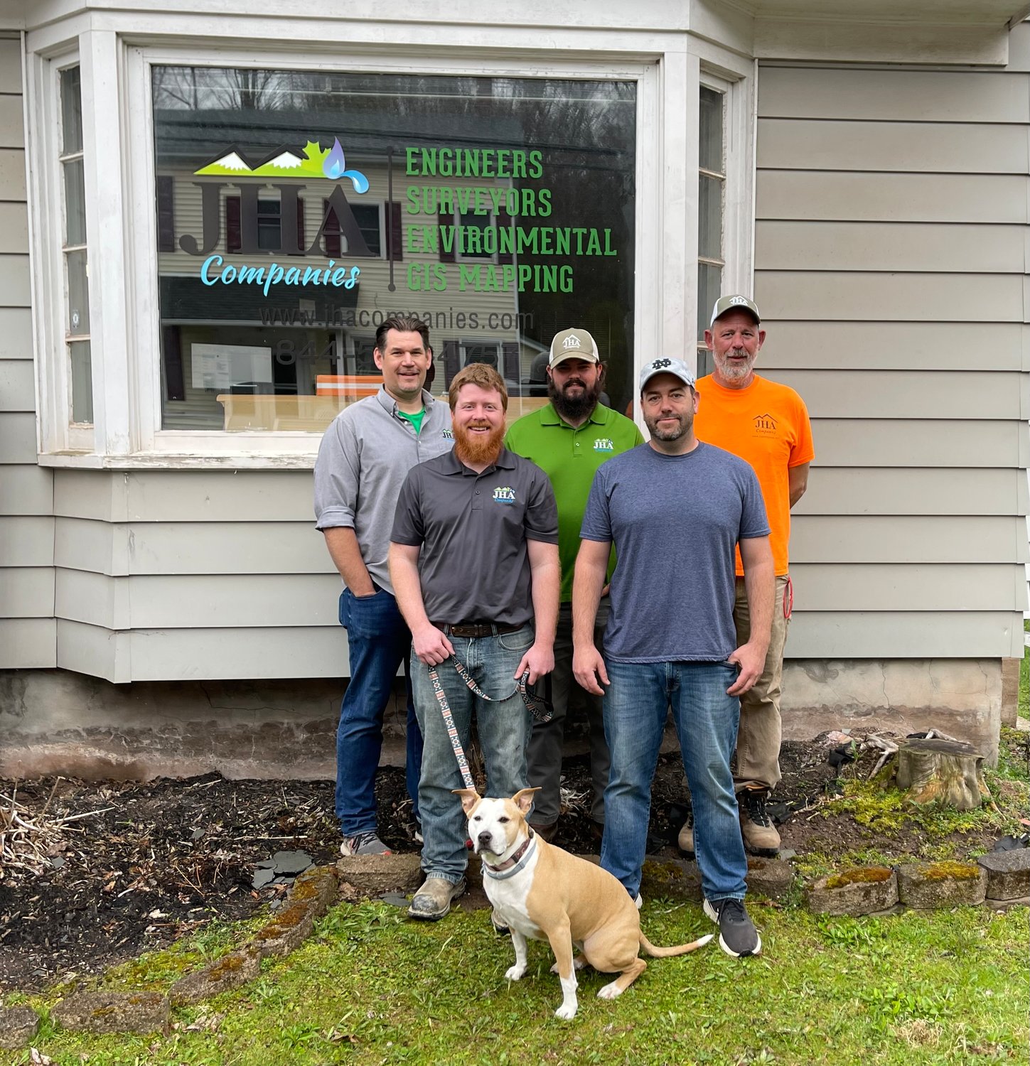 JHA Companies staff, back row, from left: Christopher Oleniacz, Rich Arnot and Matt Weaver. Front row, Nikolas Decker, Christopher Thomas and Ginger the dog.